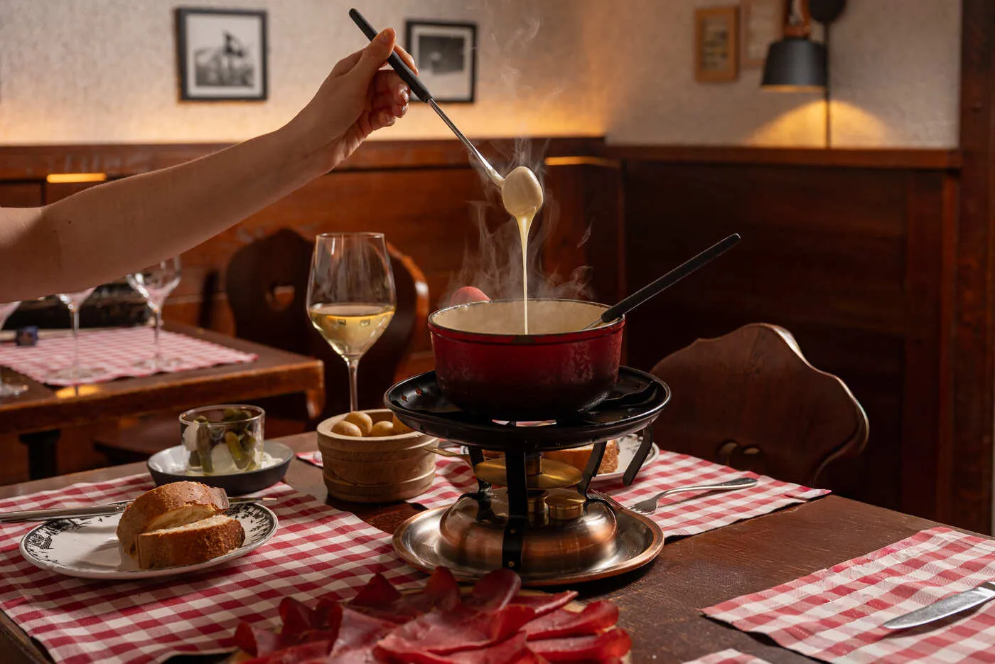 A fondue on the restaurant’s checked tablecloth