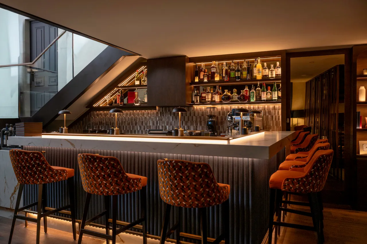 The wine bar counter, with orange stools