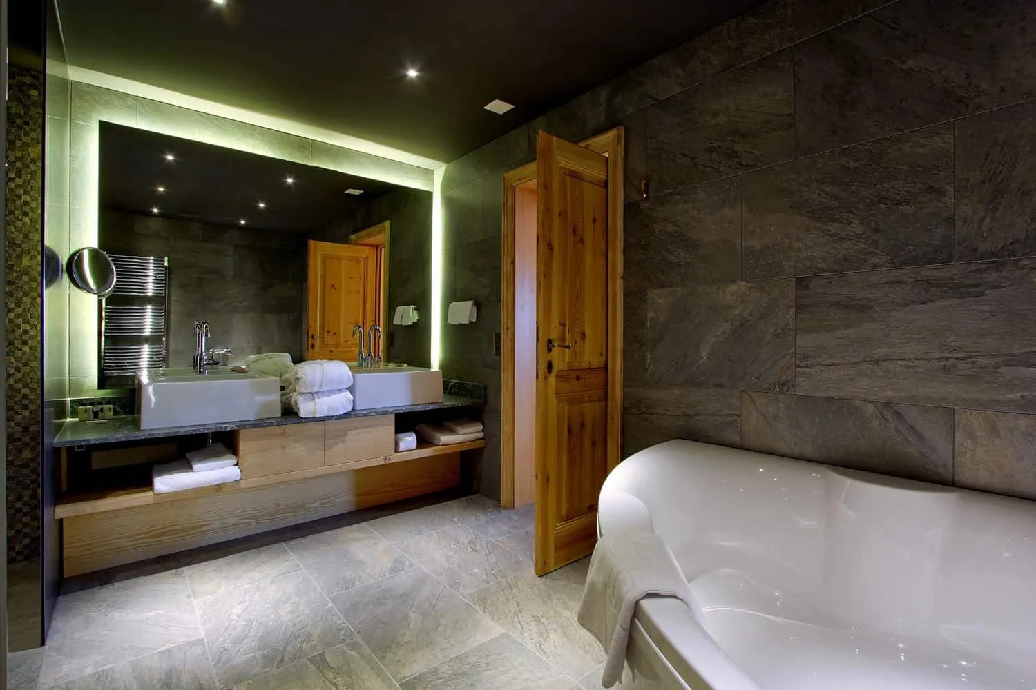 The 2 basins sit below the illuminated mirror.