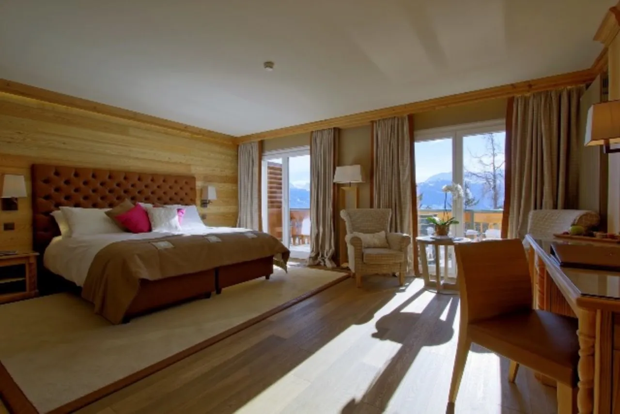 Armchairs stand beside the glazed balcony doors.