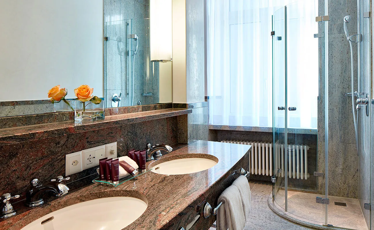 Bathroom with marble, a mirror and a shower