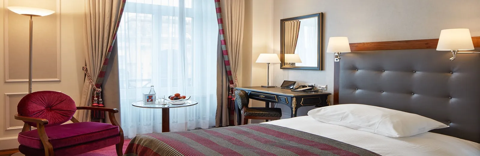 Bed and armchair in a Standard Single Room