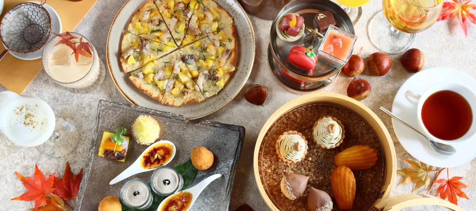 The autumn afternoon tea from above: the chestnut tart and sweets, maple leaves and a cup of tea.