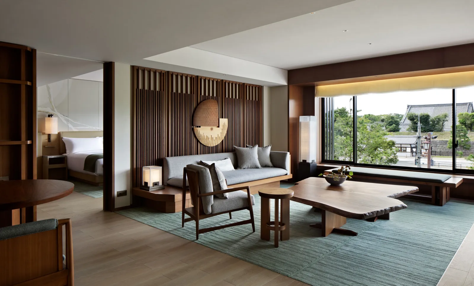 A Nijo Suite’s living room: the live-edge table, the sofa and the corner window towards the castle.