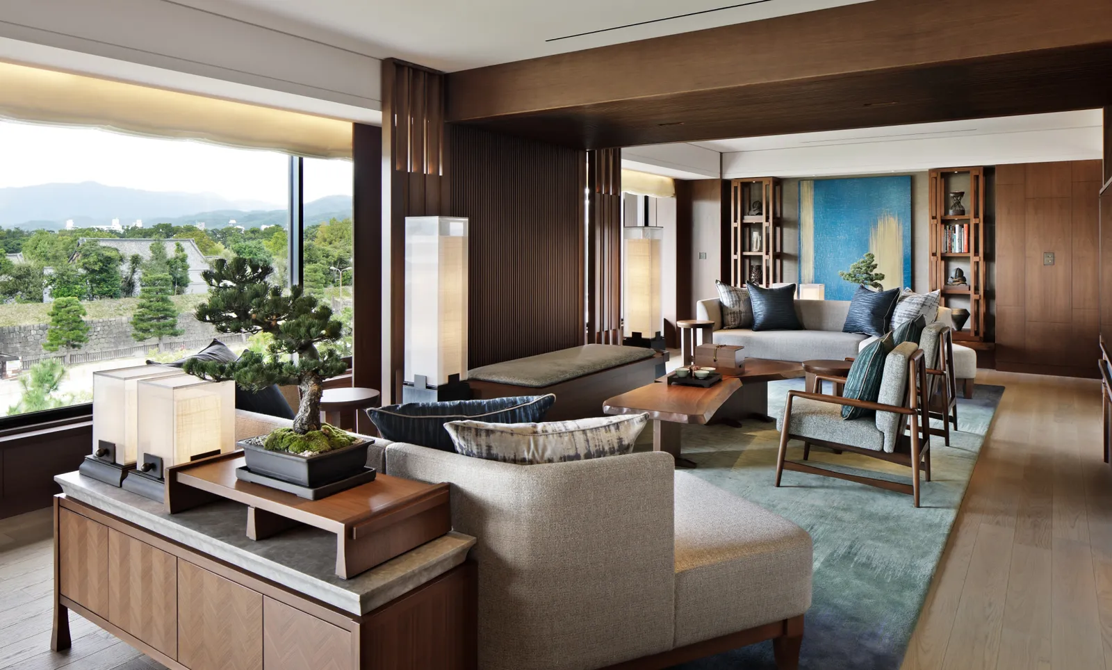 The Presidential Suite’s living room: the sofas, the bonsai on the console and the glass walls onto Kyoto’s hills.
