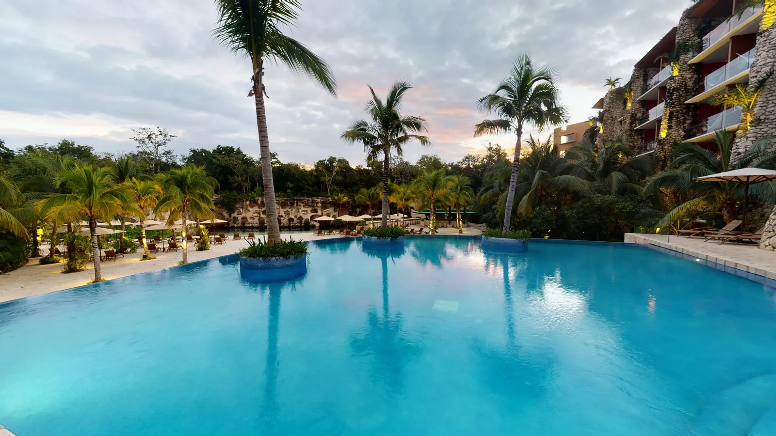 The Casa Viento pool among the palms, with the suite terraces on the right