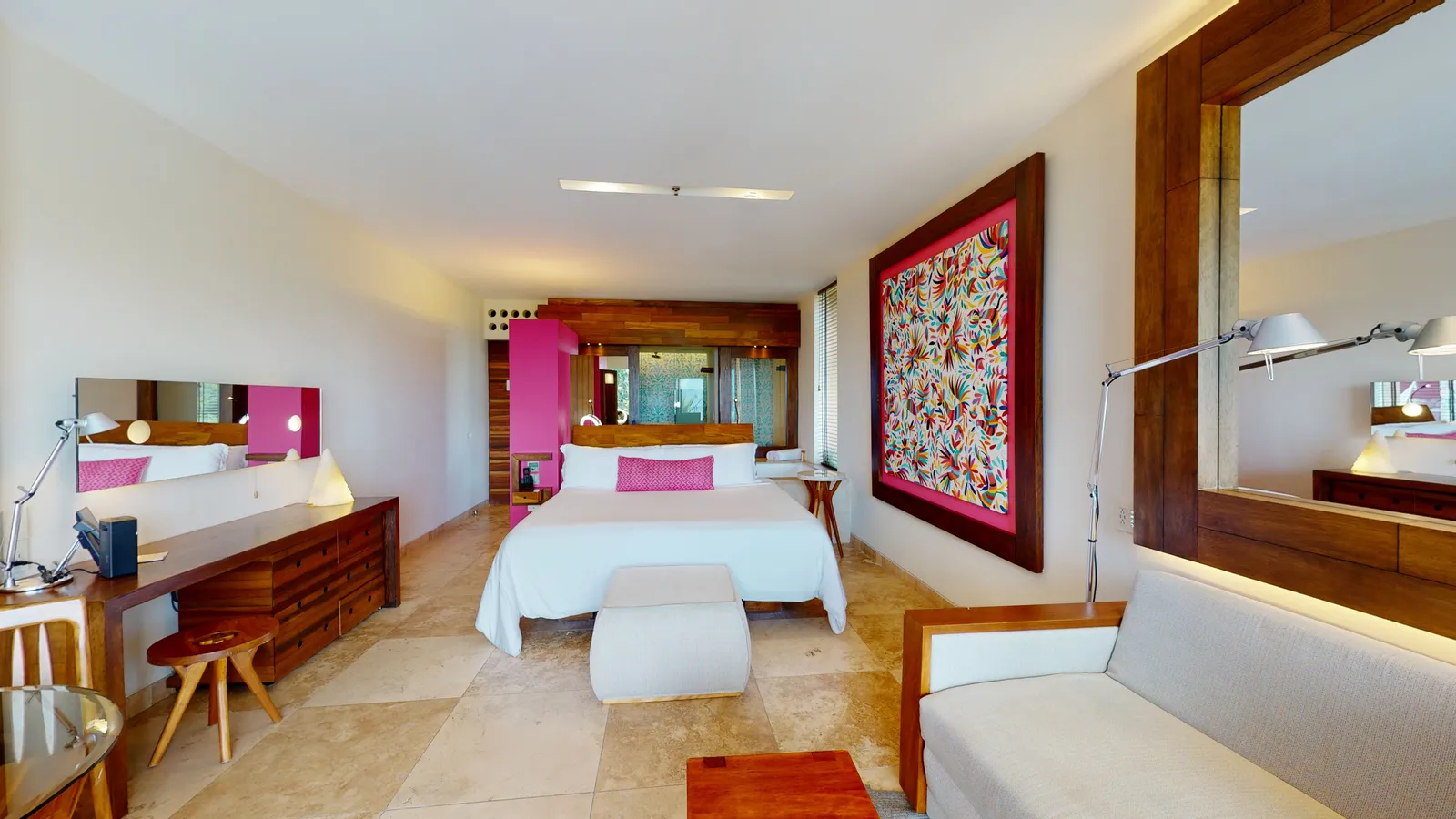 Ocean Front Family Suite with a bed, sofa and colourful artwork