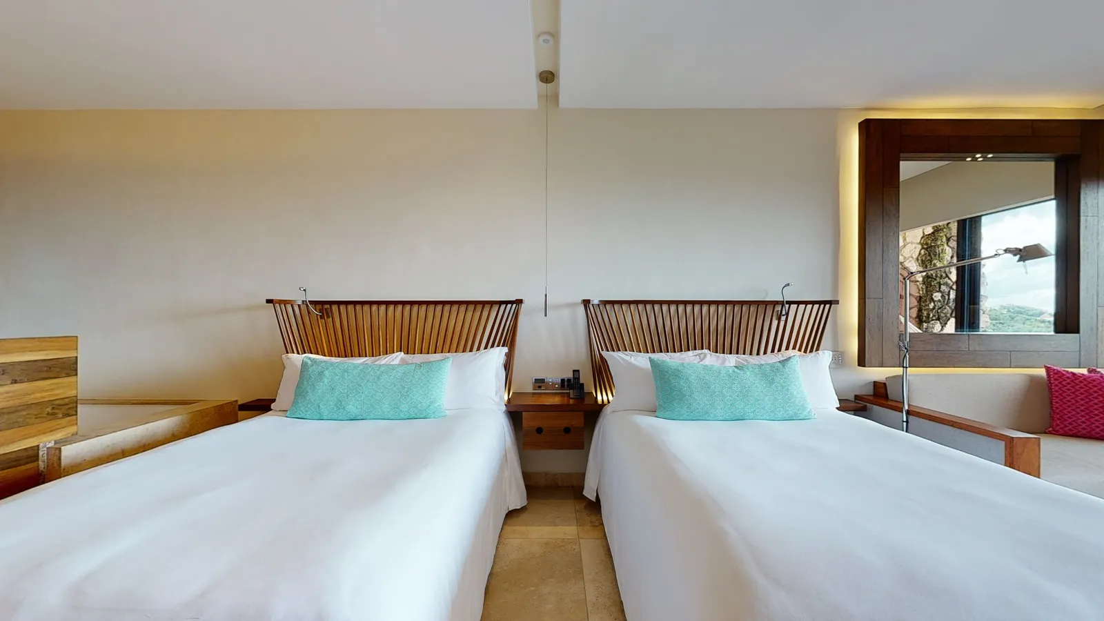 Ocean View Suite with 2 beds and a sofa beside the window