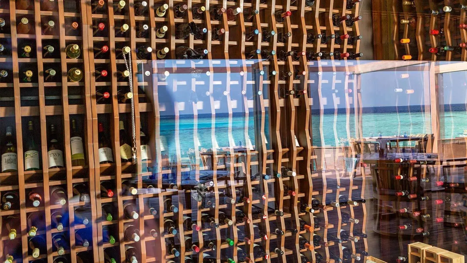 The wine cellar, walls of bottles and windows onto the sea