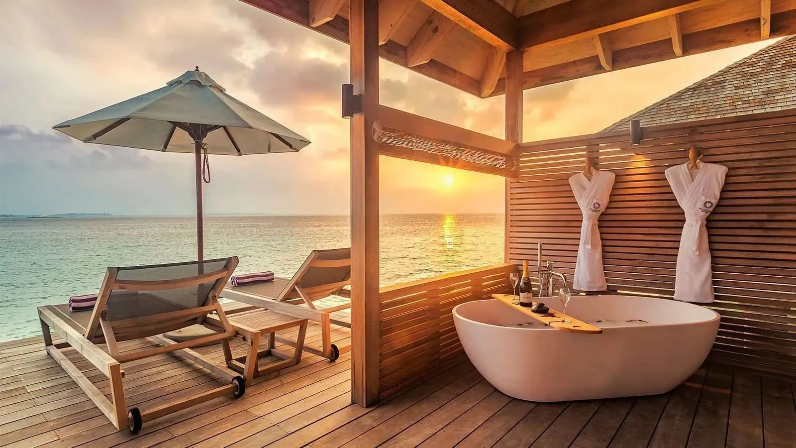 The deck bathtub of a Romantic Ocean Villa, the sea at sunset