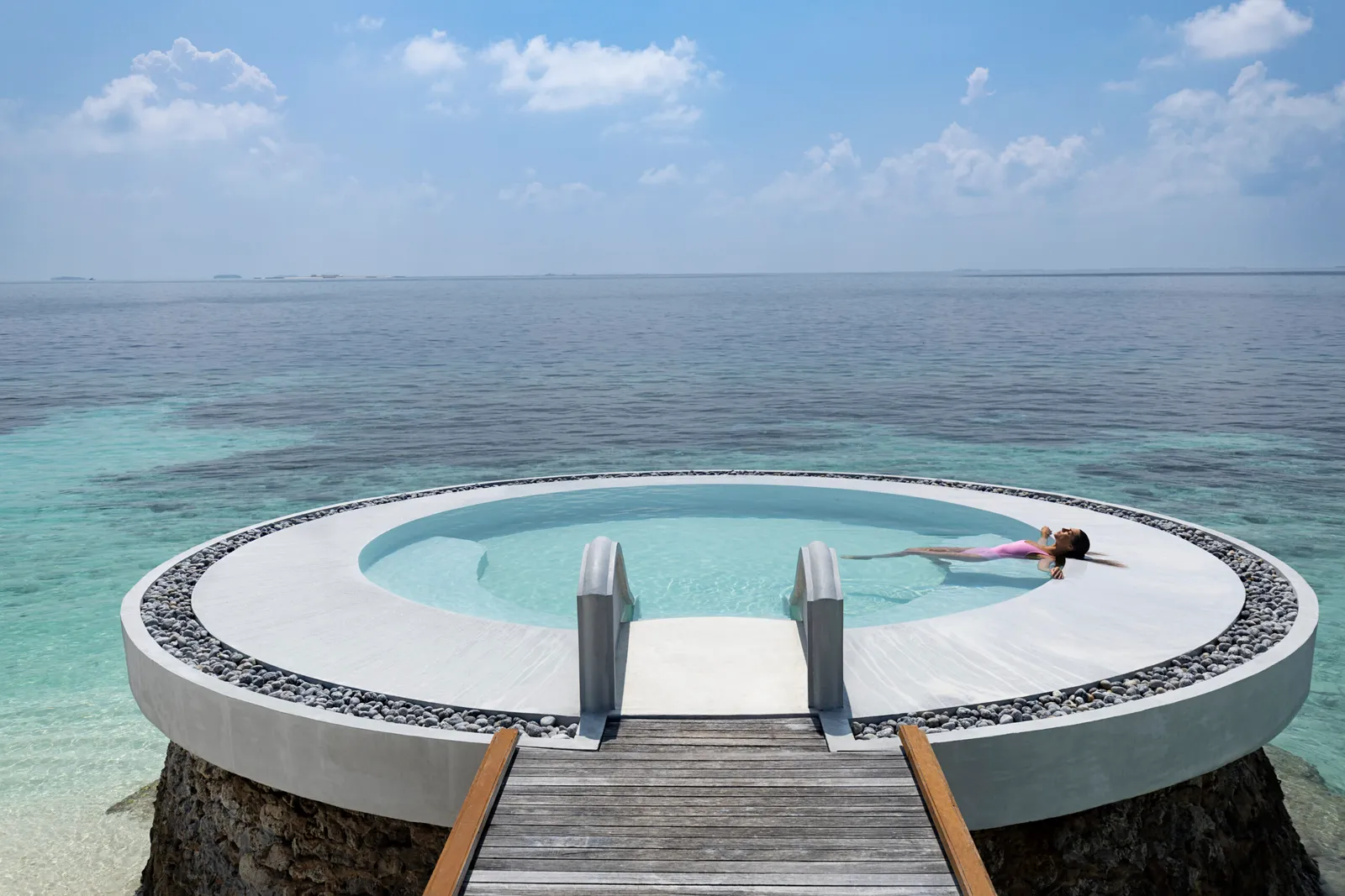 The round pool on the jetty, above the turquoise sea