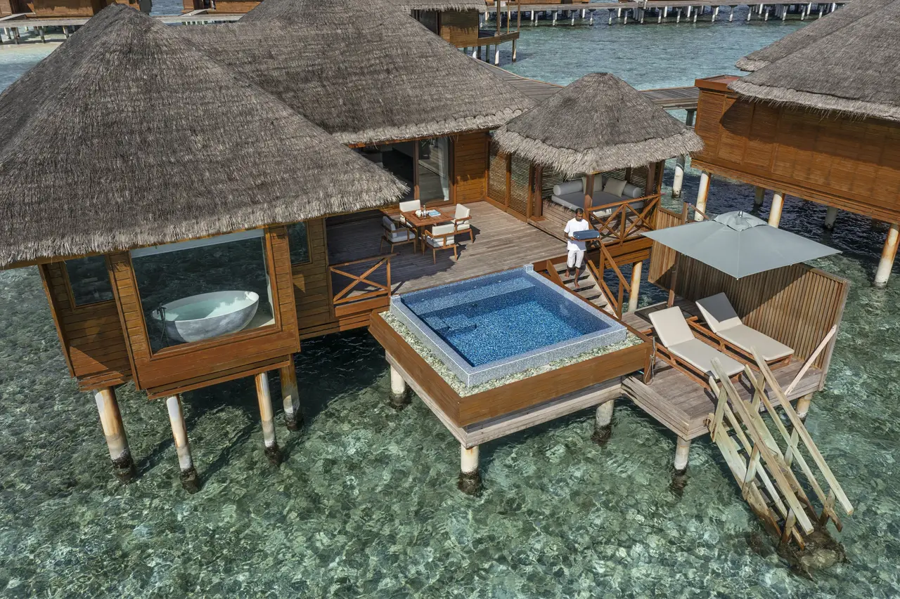 A Lagoon Bungalow over the water: the pool on its deck and steps into the lagoon