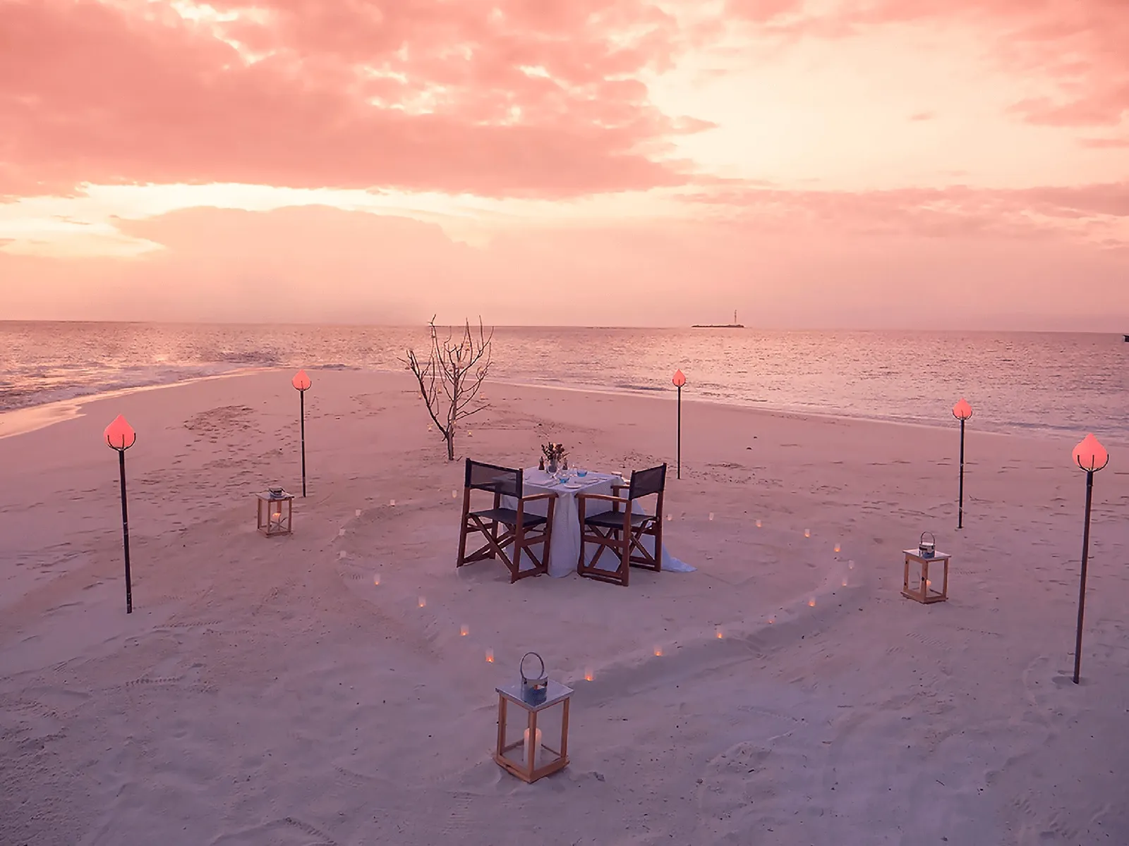 A table for 2 on the sandbank, torches alight