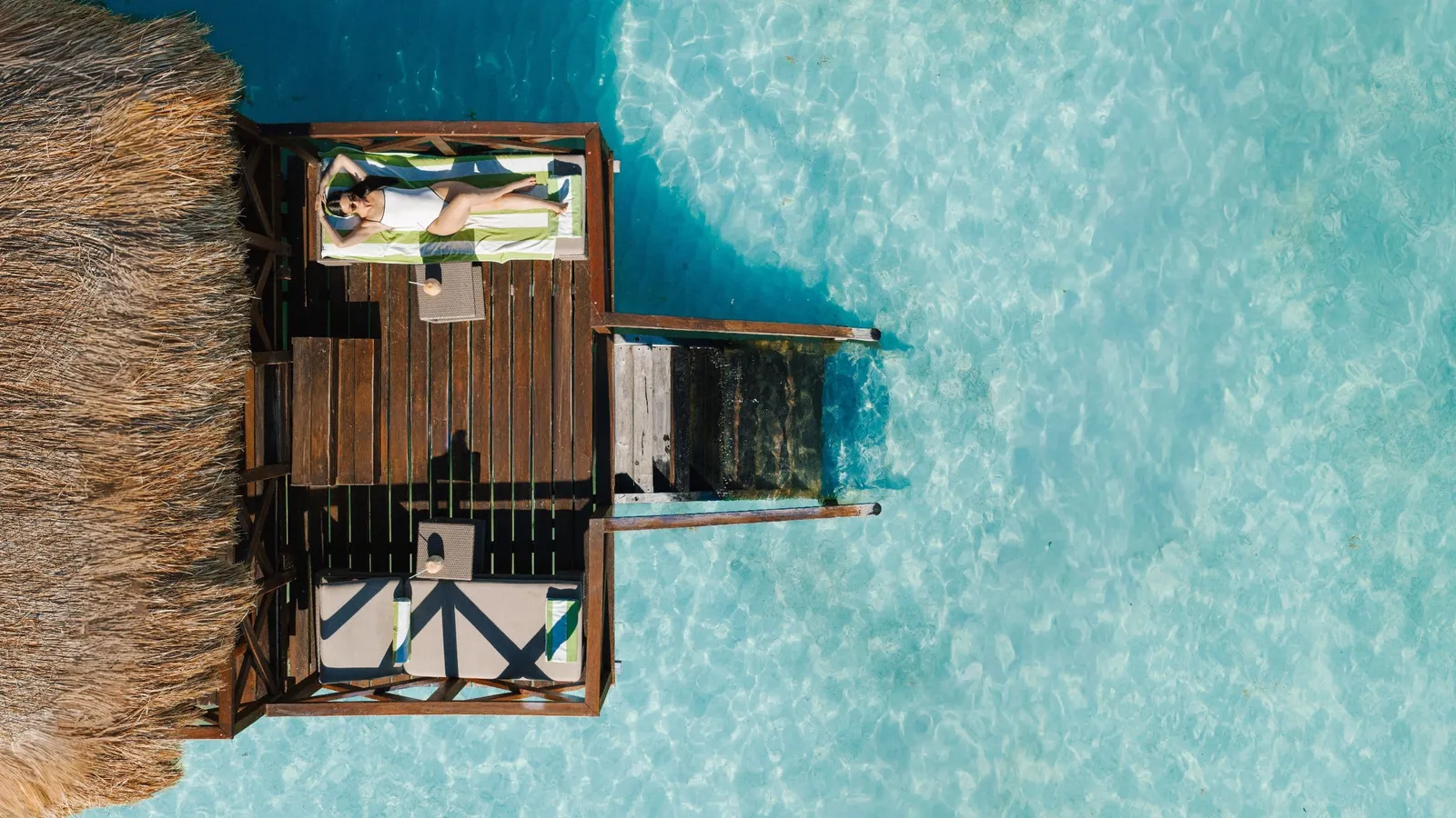 A covered pier deck above turquoise water