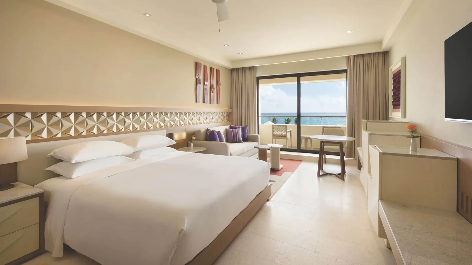A large bed and a balcony facing the sea