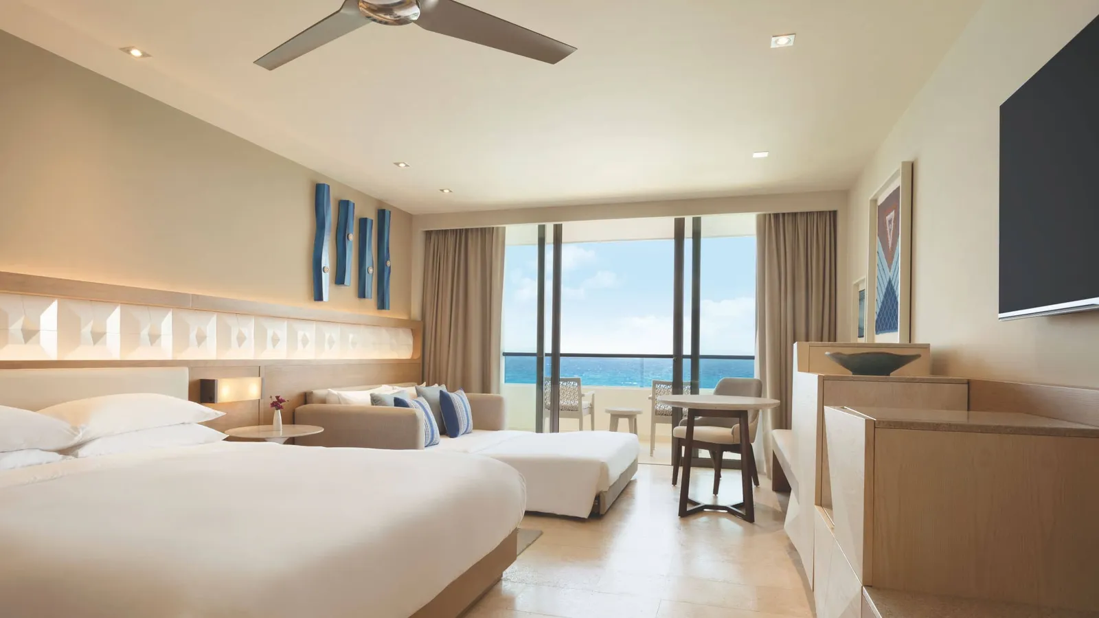 A room with a balcony opening towards the sea