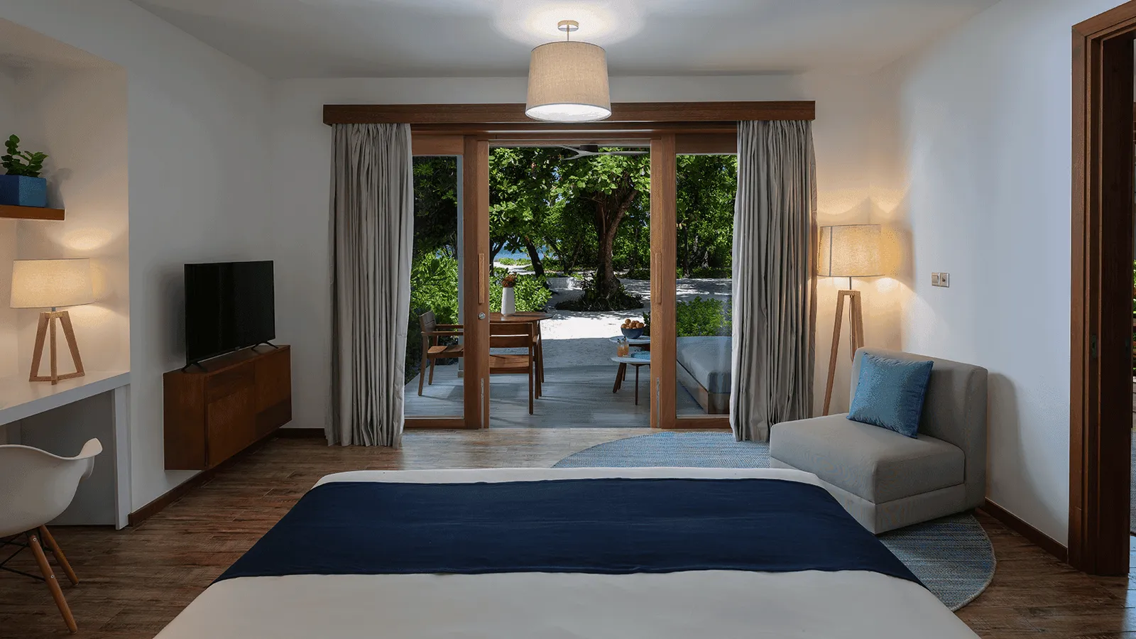 The bedroom opening onto the terrace and beach.