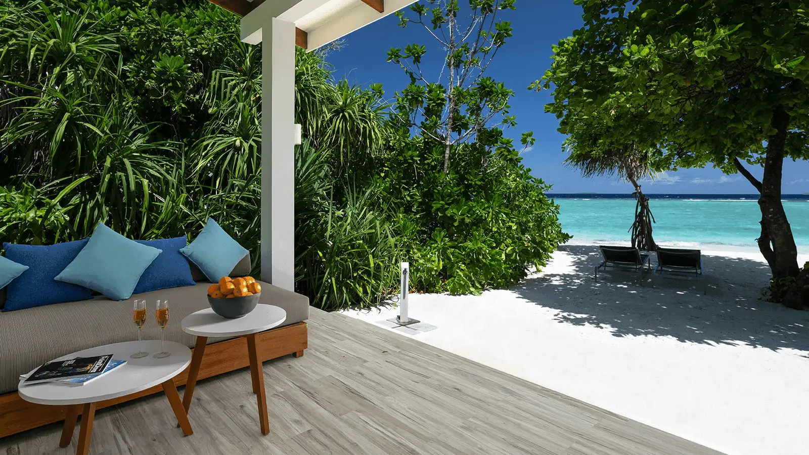 The shaded terrace with the beach beyond.