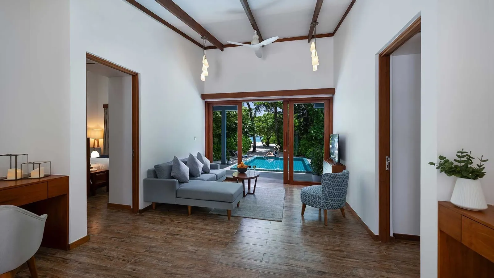 The living room with sofas and doors opening onto the terrace.
