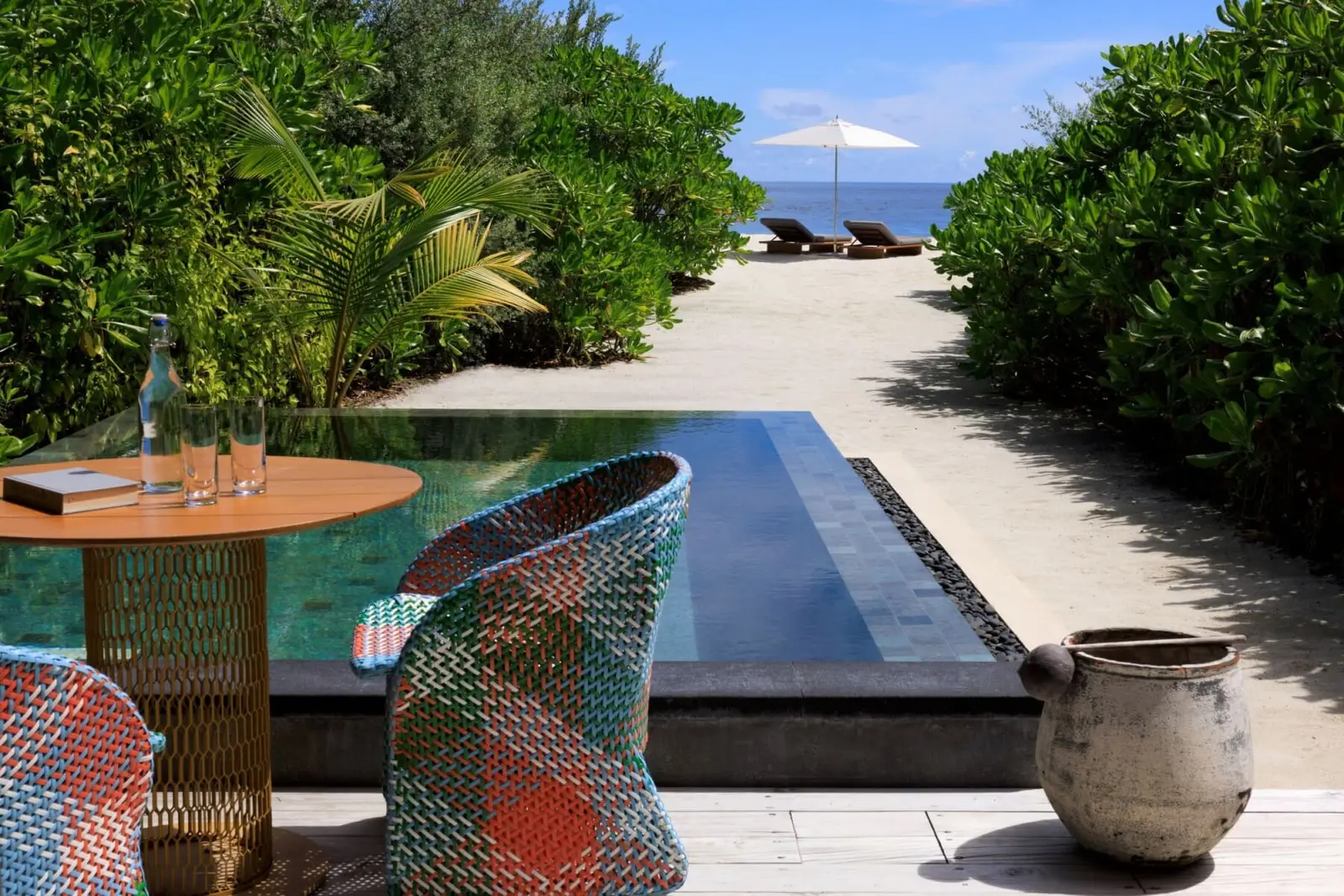 A Beach Pool Villa’s pool, the outdoor table and the path through the greenery to the loungers on the beach.