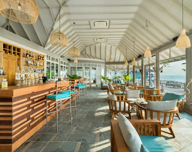 The counter, turquoise seats and sea view inside Veli Bar.