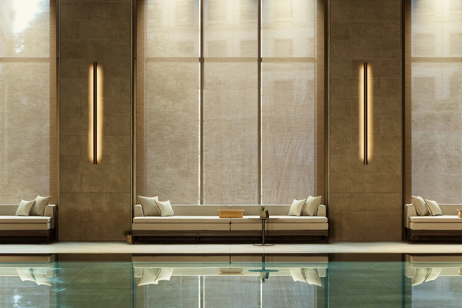 The 25-metre indoor pool: still water, loungers along the wall and tall windows veiled by blinds.