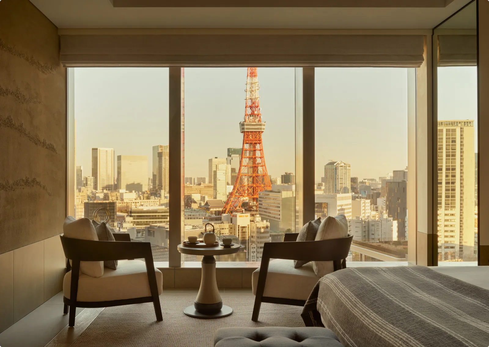 A City View Suite: 2 armchairs at the window and Tokyo Tower in the middle of the view.
