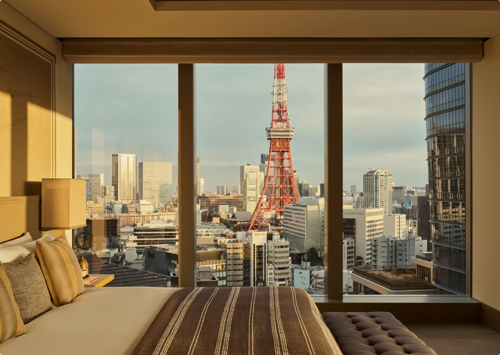 The Janu Suite: the bed facing the window and Tokyo Tower among the buildings.