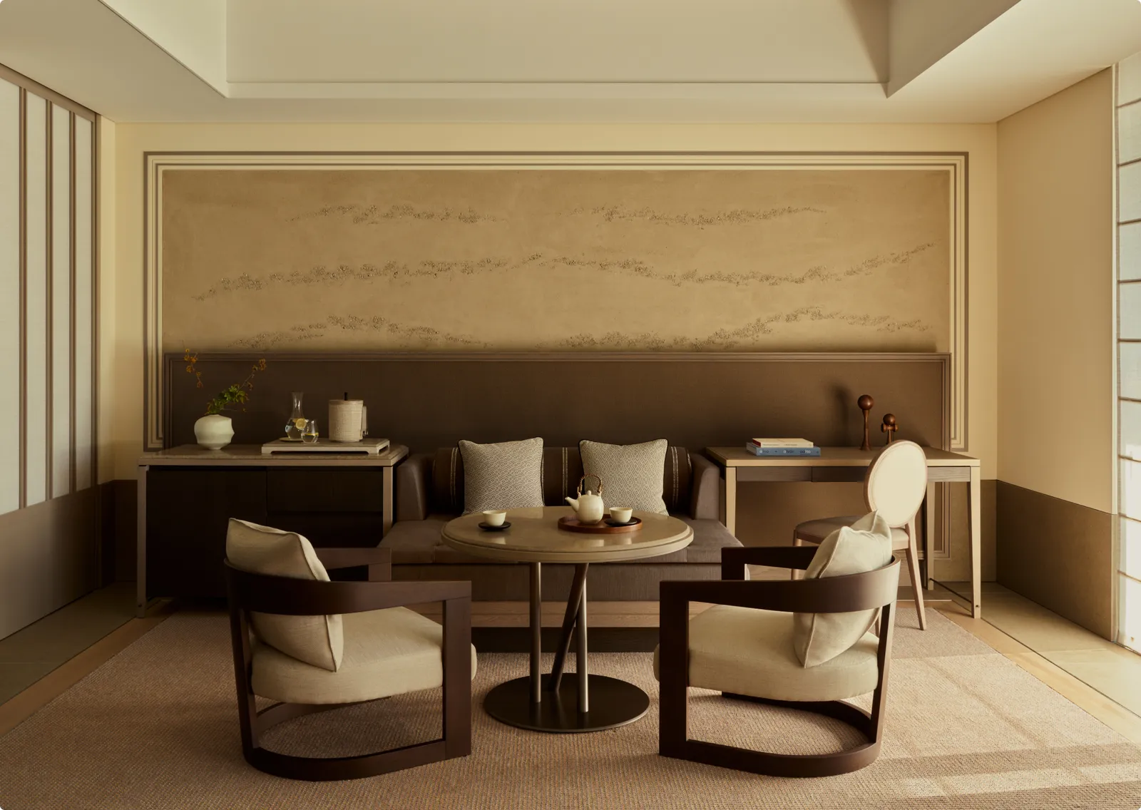 A Premier Room: 2 armchairs and a low table in front of the daybed, under the plaster panel.