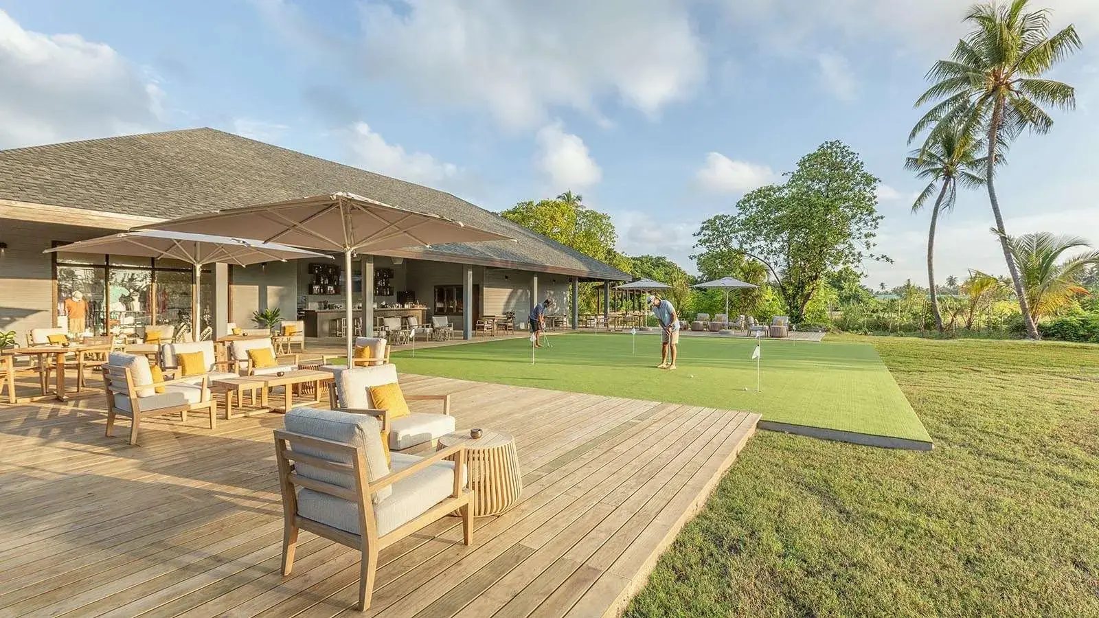 Hideout’s terrace beside the golf course, with the green and the palms