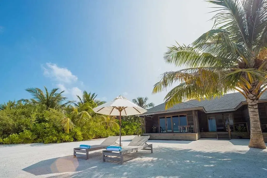 A family villa on the Mabin beach, with loungers and a parasol
