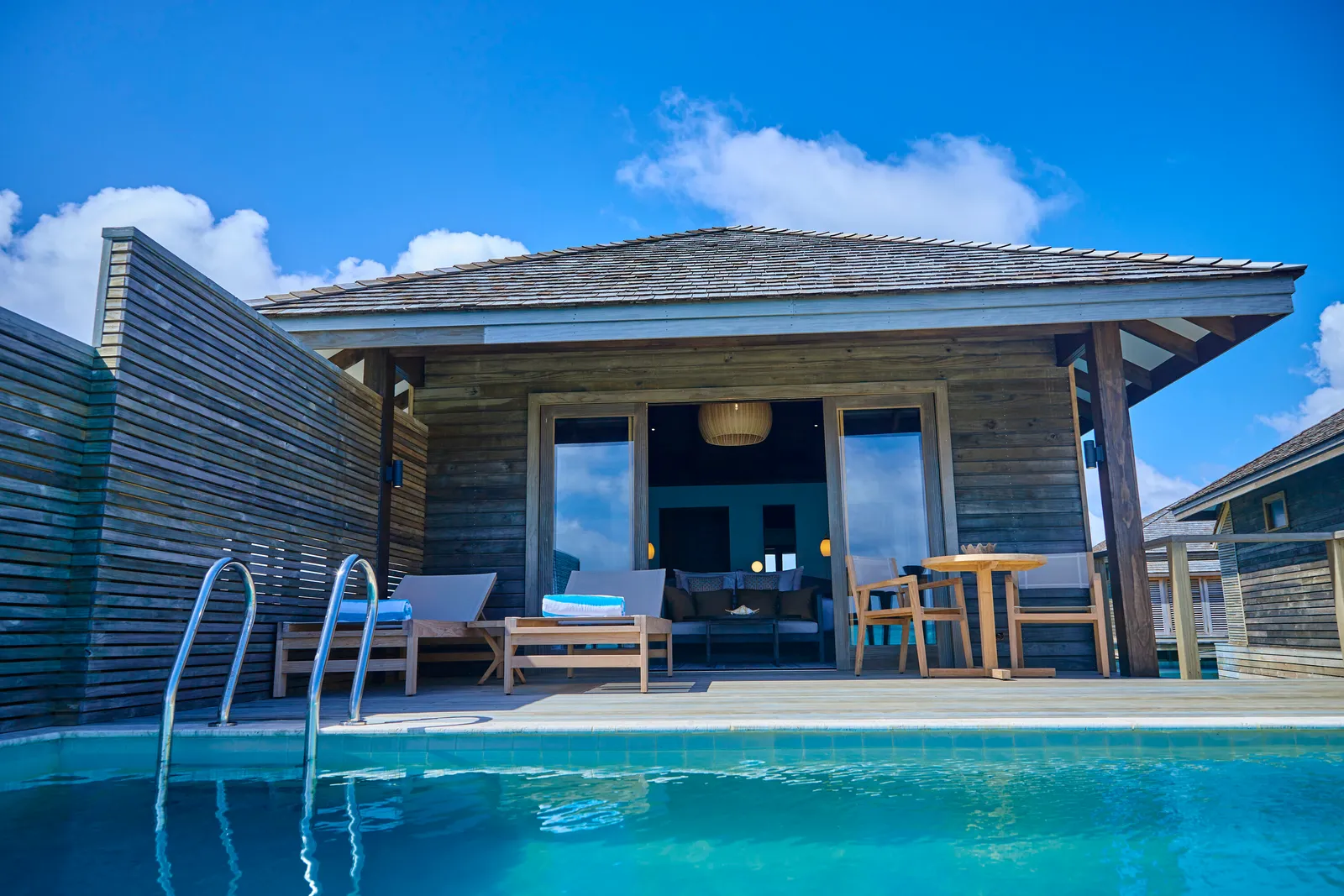 A Water Pool Villa seen from its pool, with the deck and the steps