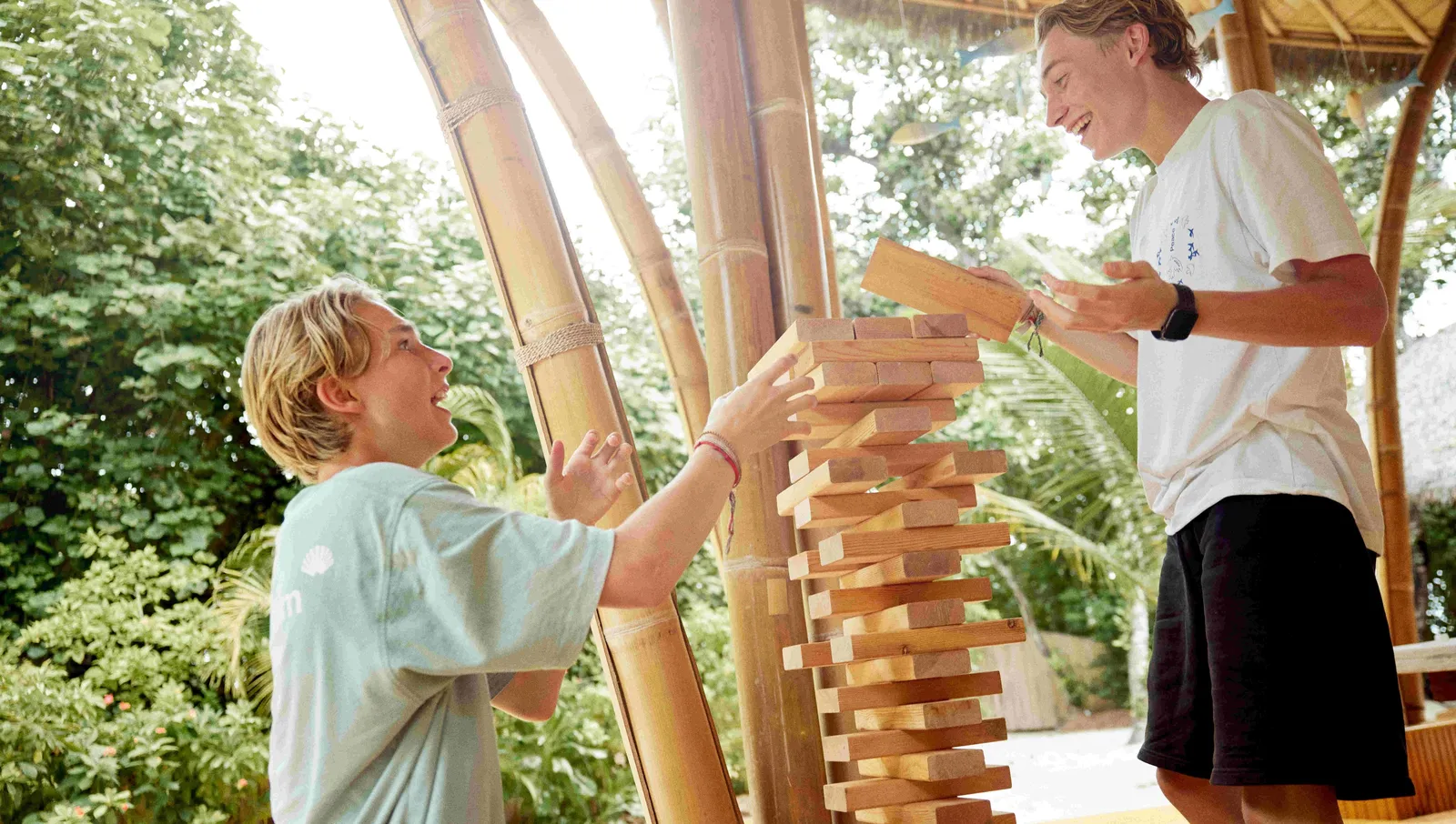 A boy and an instructor playing a wooden tower game at B’Kidult