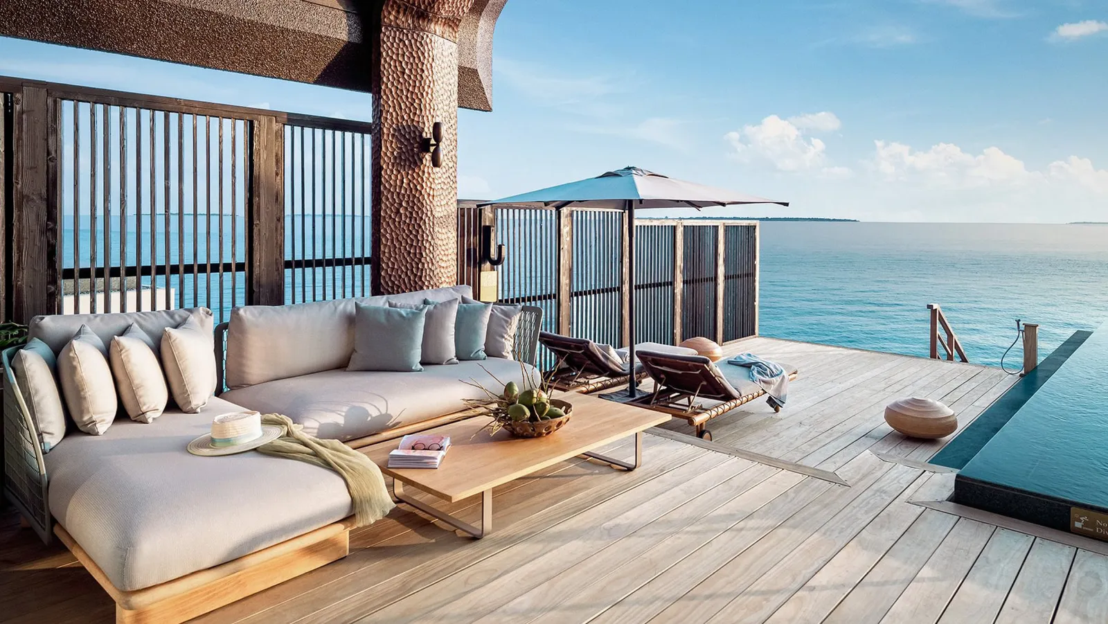 A Two Bedroom Ocean Pool Villa’s deck, its sofa and the sea