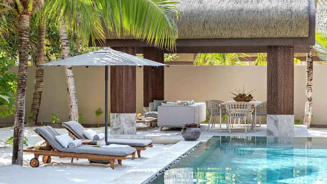 The pool and outdoor table of the Two Bedroom Wellbeing Beach Pool Residence