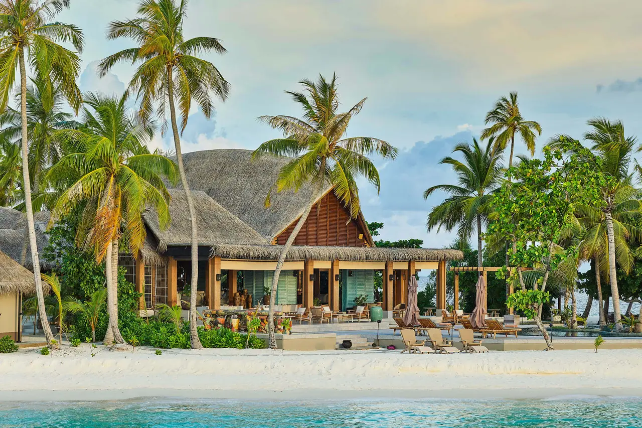 Mura Bar on the beach, its thatched roof among the palms