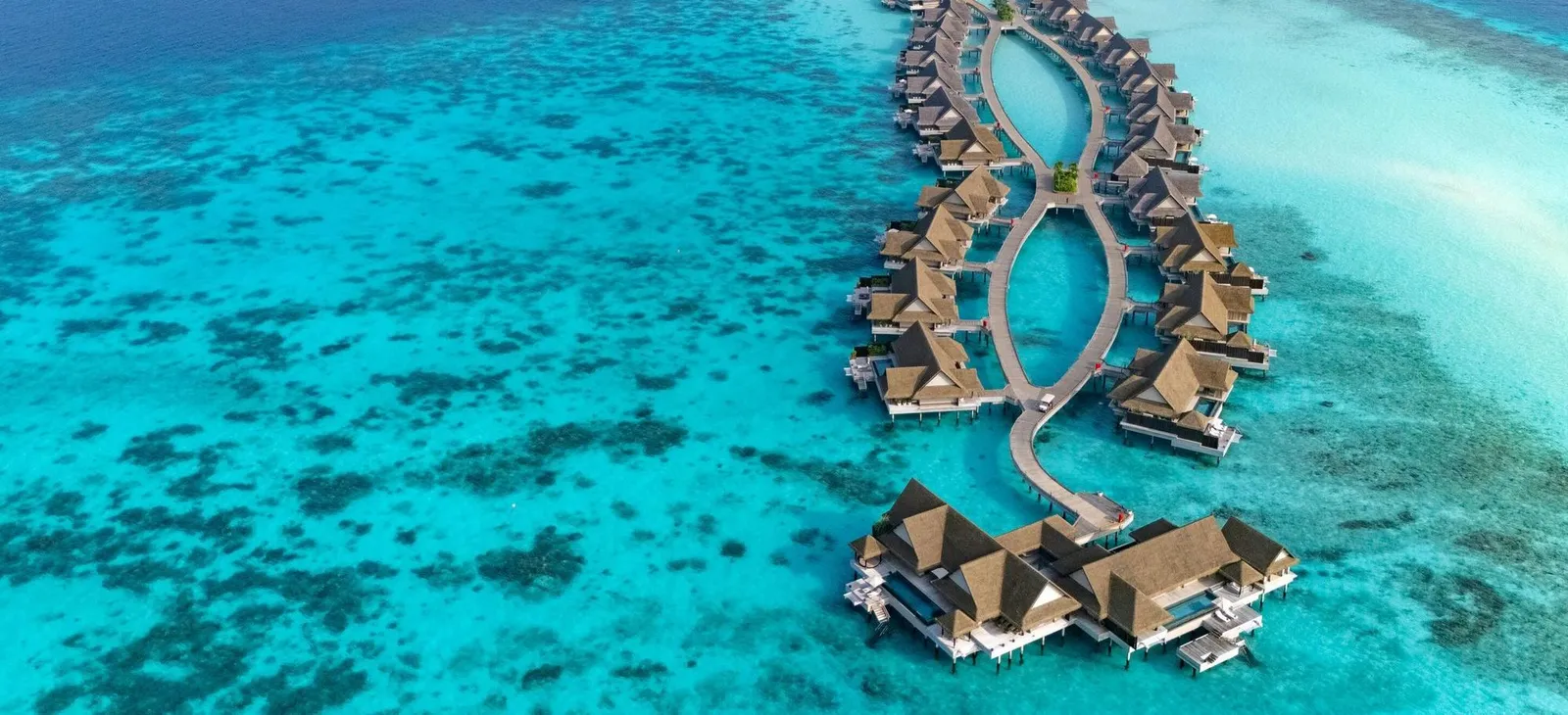The water villas from the air, along their jetty