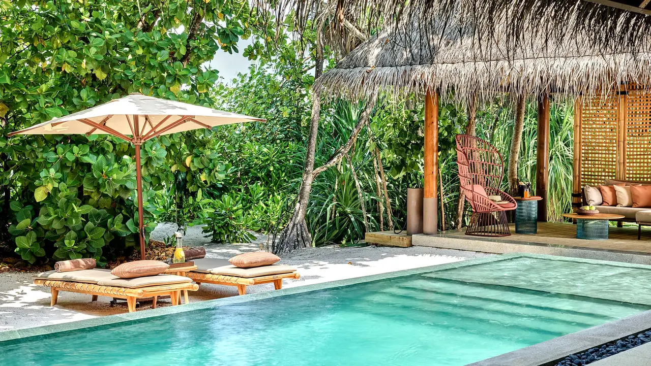 A Luxury Beach Villa with Pool’s pool, among the greenery