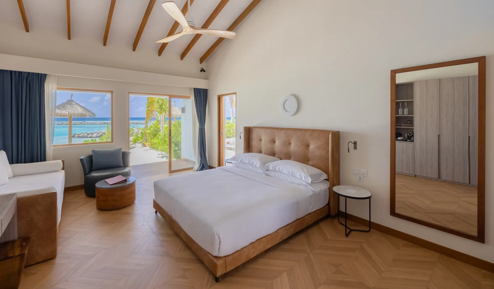 A Family Beach Villa’s bedroom: the double bed, the sofa and the beamed ceiling
