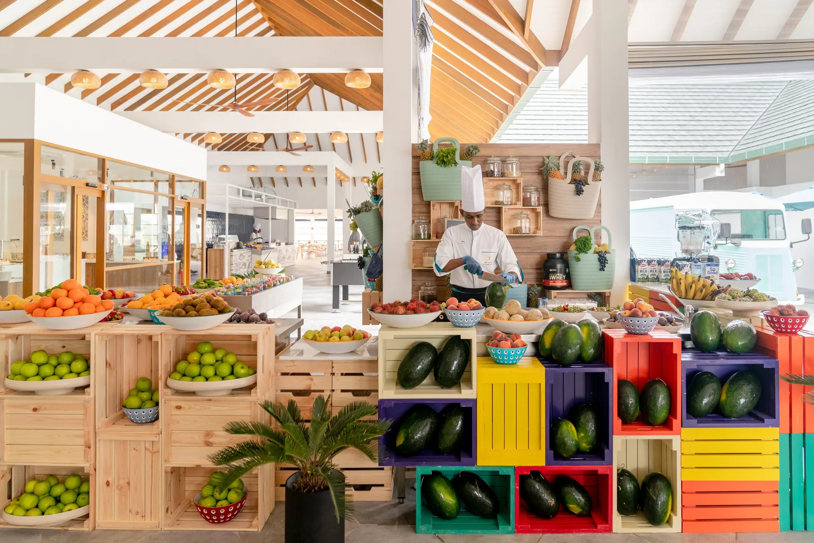 The Market’s buffet: colourful crates of fruit and vegetables, a cook at the counter