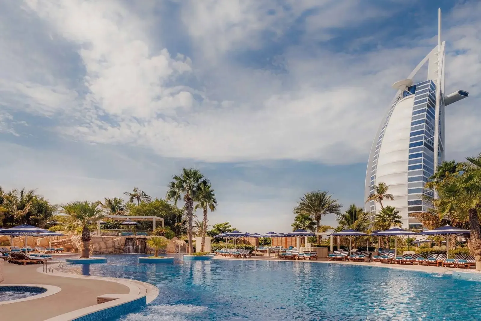 The pool among palms with the Burj Al Arab behind