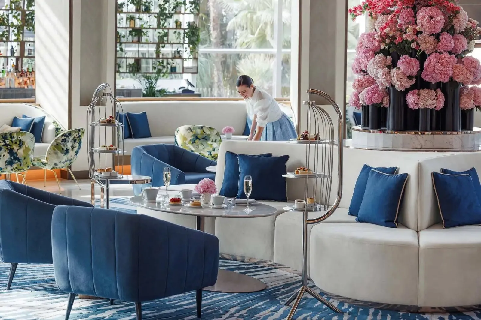 Pearl Lounge’s sitting room with blue armchairs and flowers