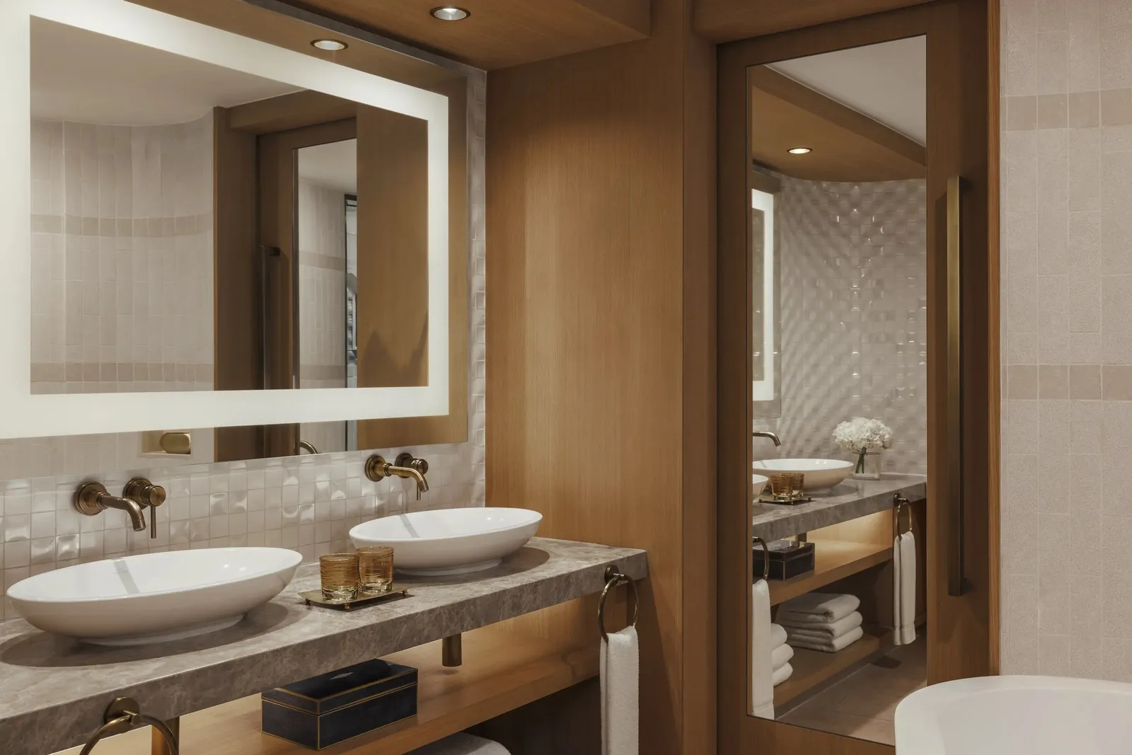 The bathroom with 2 basins and a lit mirror