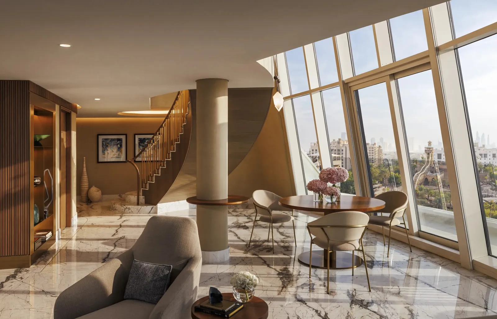 The suite’s double-height living room with its spiral staircase