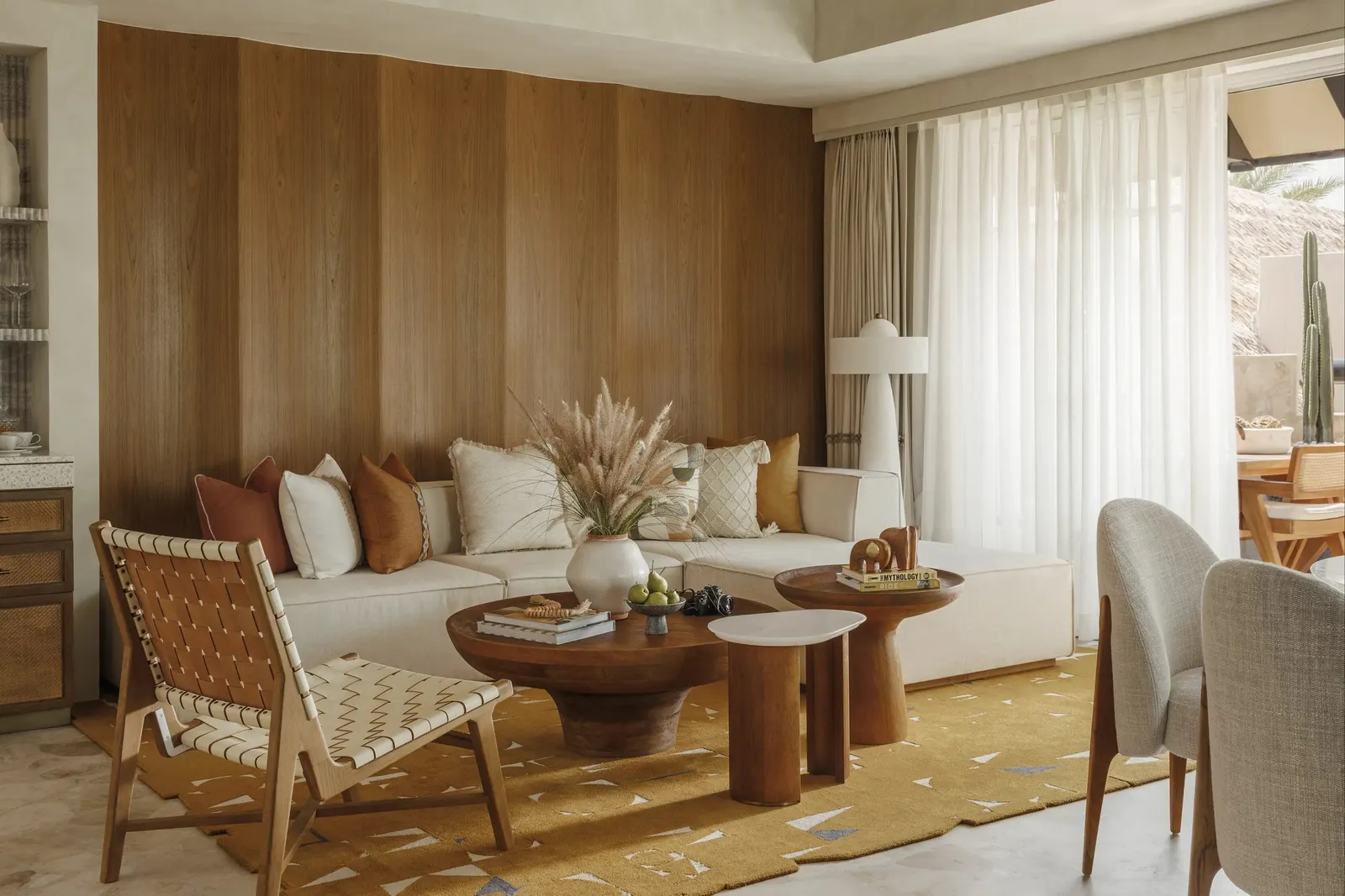 A villa living room with a pale sofa and a wooden coffee table