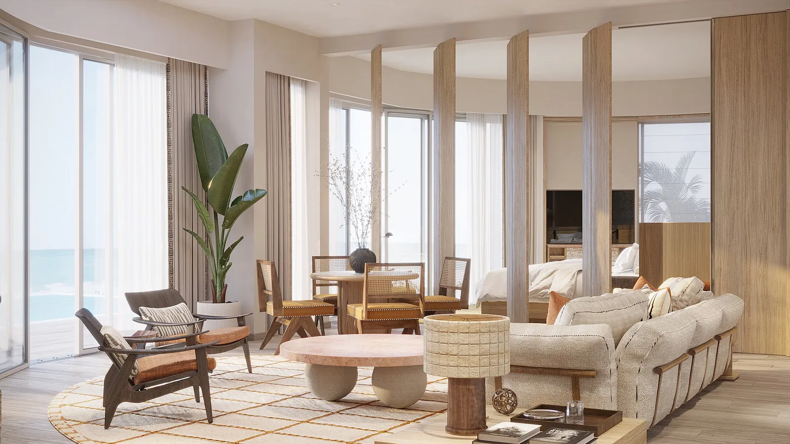 A villa living room with floor-to-ceiling windows, a potted palm and pale sofas