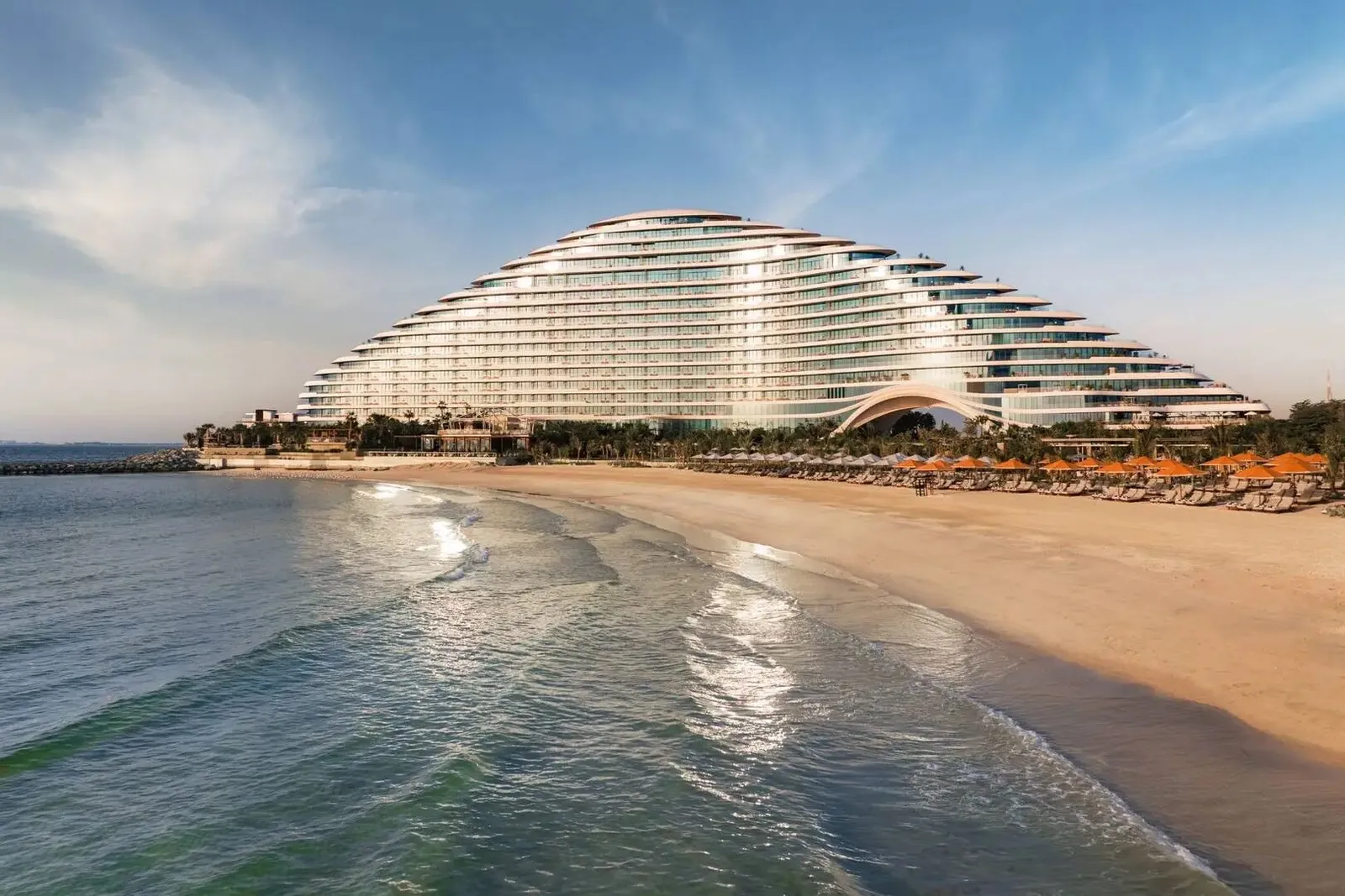 The resort’s curved terraces above its beach
