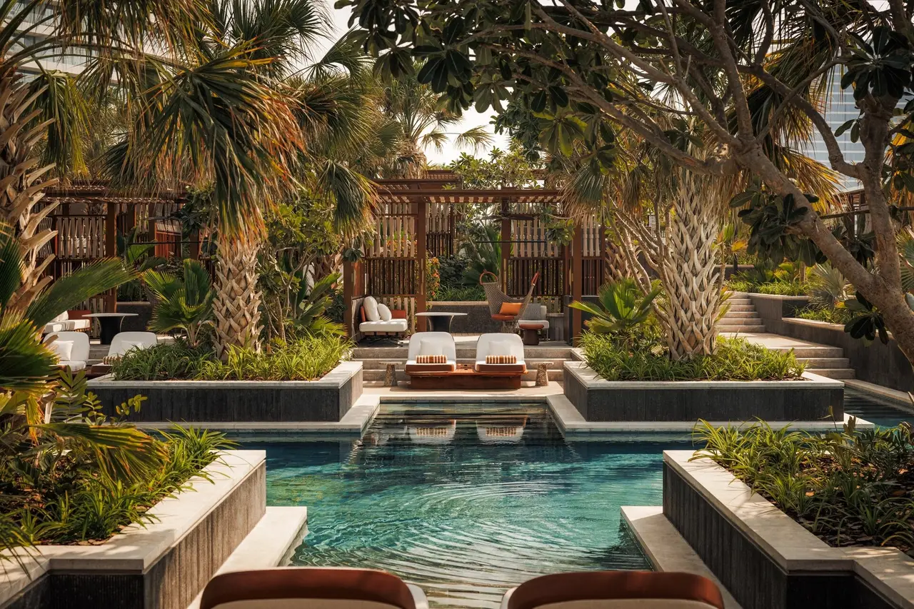 A pool among palms and pergolas