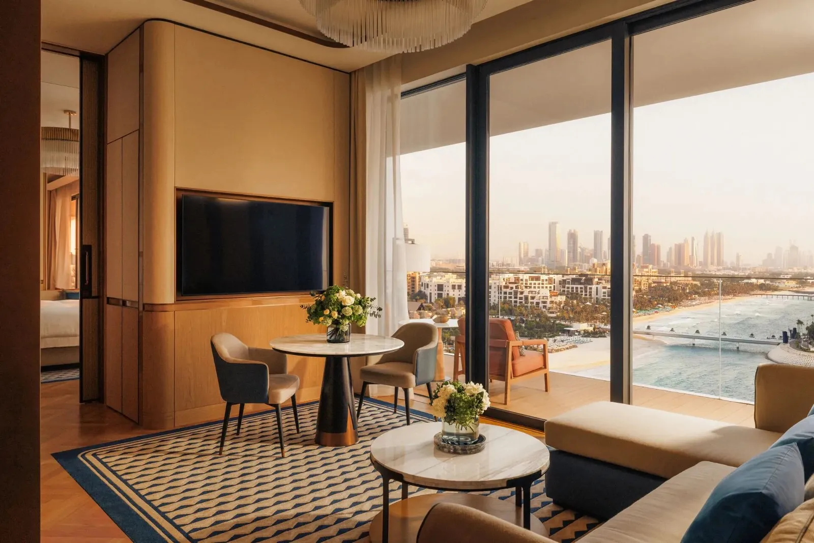 A sitting room with a dining table and a view along the coast