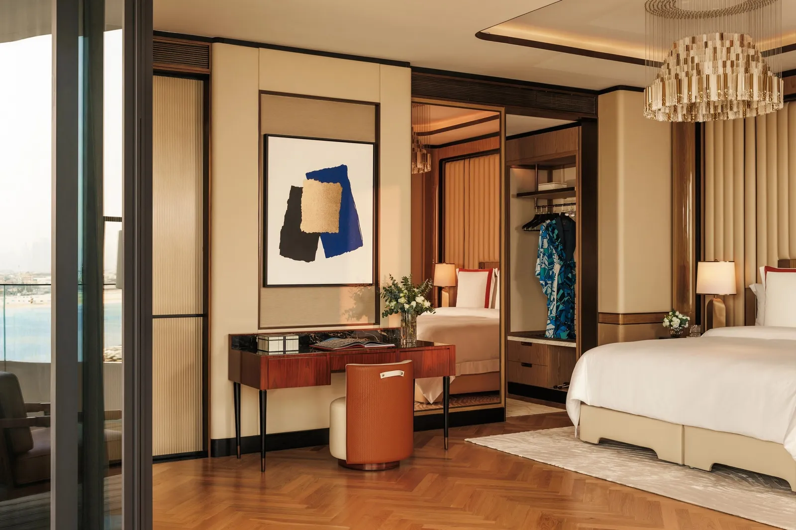 A bedroom with glass walls onto the open sea